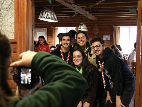 A planning team member takes a picture of 4 Rovers that smile at the camera.