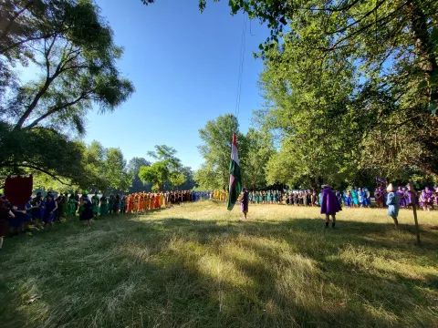 A campsite with a Hungarian flag hanging.