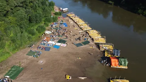 Rafts parked in line on the riverside.