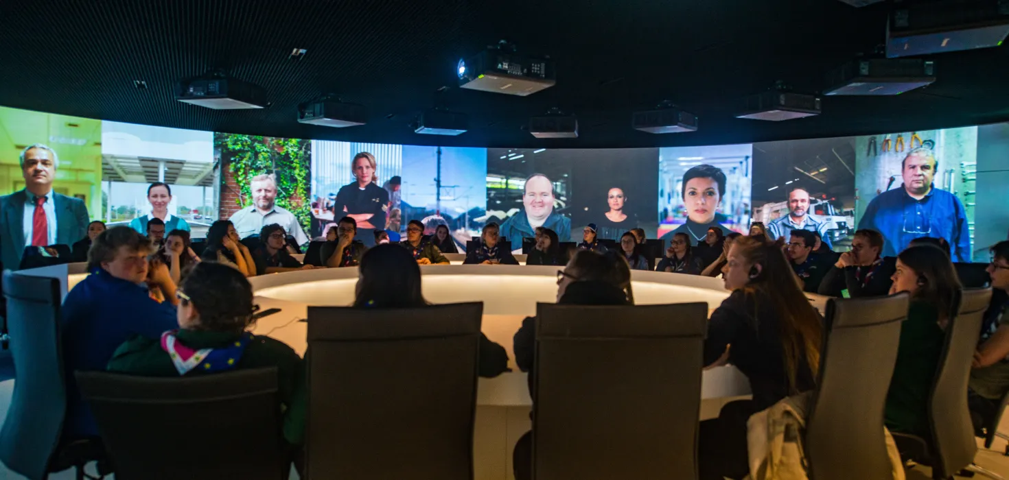 Young people sit on a round table at the European Parliament in Strasbourg.
