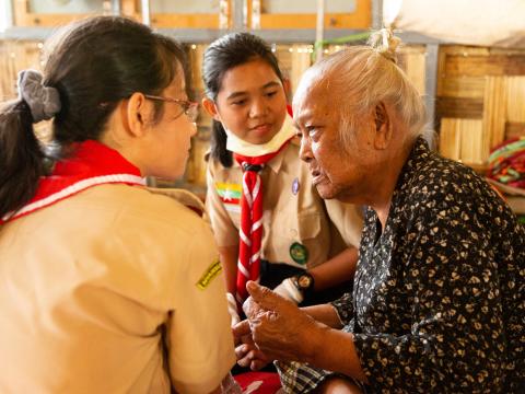 scout helping an elder woman