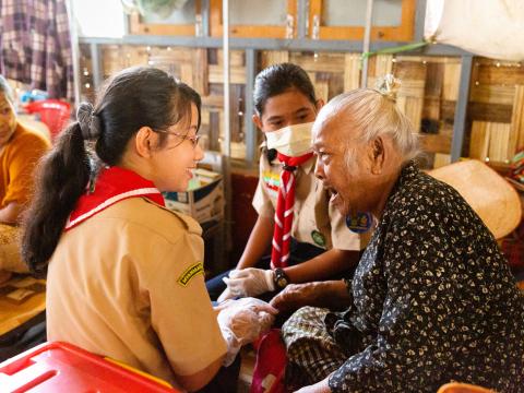a scout sitting with an elder talking