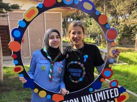 Nour Mahmoudi (left) poses with Generation Unlimited sign