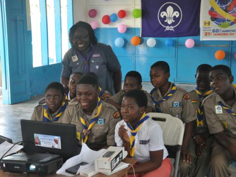 Scouts gather around a computer during the Jamboree On The Internet JOTA-JOTI