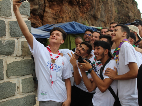 Happy Algerian Scout youth taking a selfie