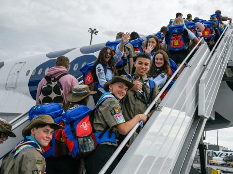 French Scouts board a plane en route to the World Scout Jamboree in South Korea