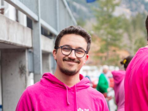 A man wearing a pink hoodie.