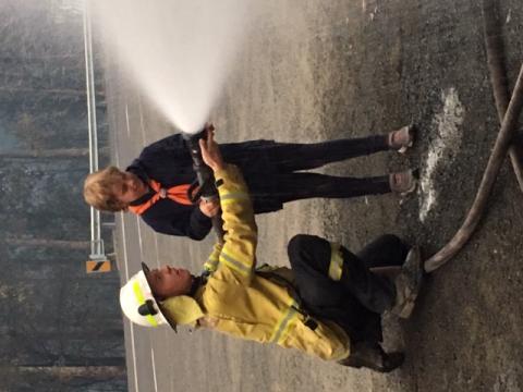 Luke, in a rural town of New South Wales (NSW) spends hundreds of hours over Christmas actively fighting fires and ensuring his fellow community members have evacuation plans in place. Luke, pictured here with a firefighter and hose.