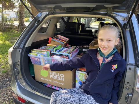 Hearing stories of people just like her losing everything in the floods, Chloe takes matters into her own hands and sets up a local donation spot to bring together her community to support people across the country. Chloe is pictured here in the back of a car with boxes of donations.