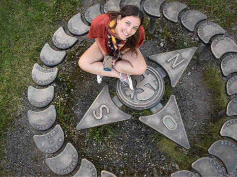 Elisaveta sitting on the floor, on top of some pieces marking the cardinal points.