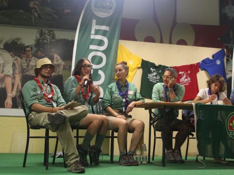 A group of young people wearing Scout uniforms are part of a panel.