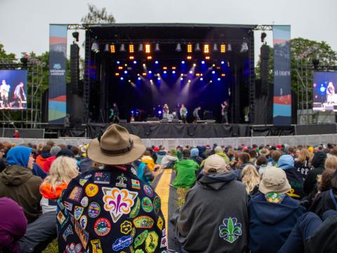 Participants from Landsleir sit in front of a big and colourful stage.