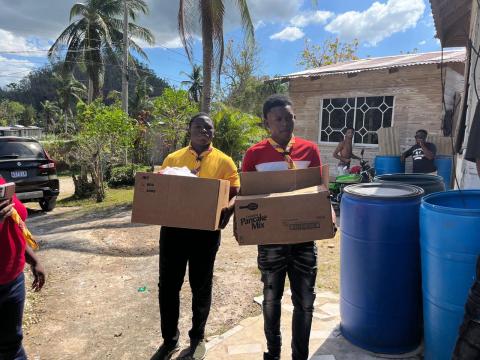 Scouts holding boxes