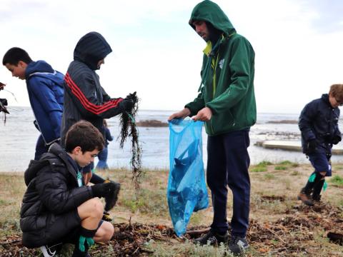 Scouts collect litter from a beach in Portugal.