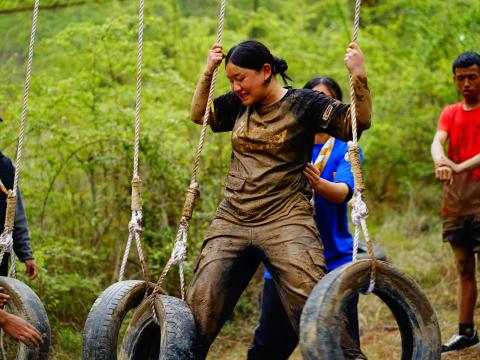 A Scout from Bhutan perseveres to complete a relay challenge