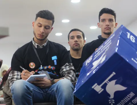 Young Algerian men take notes