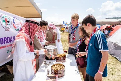 Scouts visit the Jordanian table to learn about their culture during the World Scout Jamboree in 2019