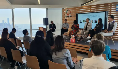 At an event at SAP America, participants watch as speakers take the stage, including Scouting, Youth Representative named Paul