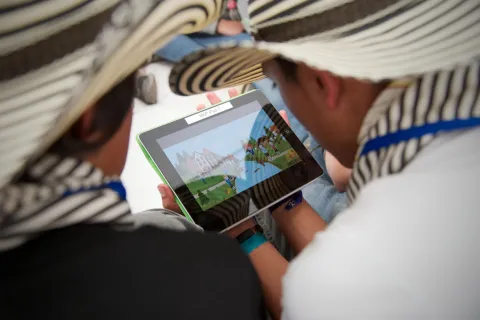 A Colombian Scout looks at a tablet during JOTA-JOTI