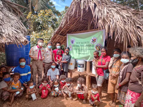 Raymund Romeo Guzman in front of a Boy Scouts of the Philippines sign