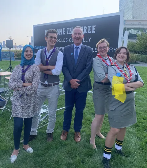 Scouts pose with Robert Jenkins, Global Director of Education and Adolescent Development for UNICEF, at the United Nations