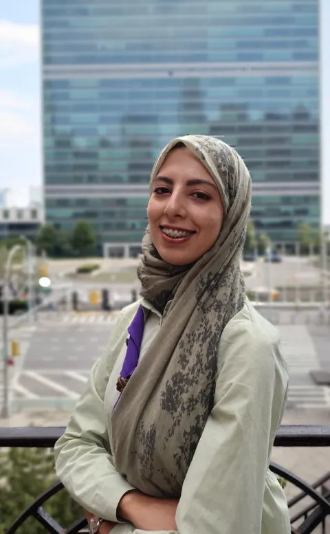 Scout Nadine Shili poses in front of the United Nations headquarters in New York City