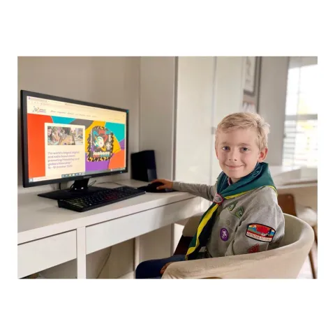 A Canadian Scout sits at his desk during JOTA-JOTI as he participates in World Scouting's annual digital jamboree