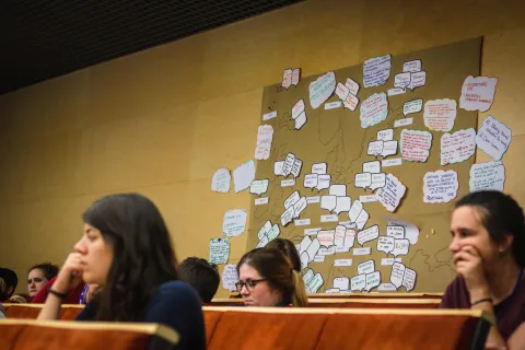 Scouts attending session of the forum with a map of Europe in the background