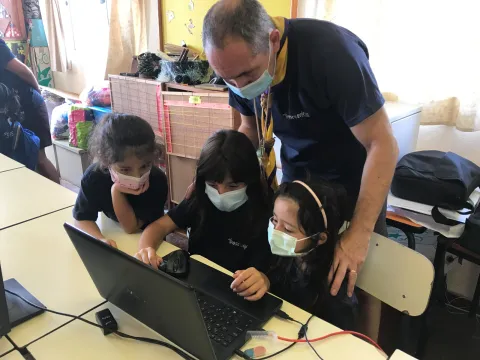 A Portuguese Scout Leader checks in on Scouts participating in JOTA-JOTI on their laptop