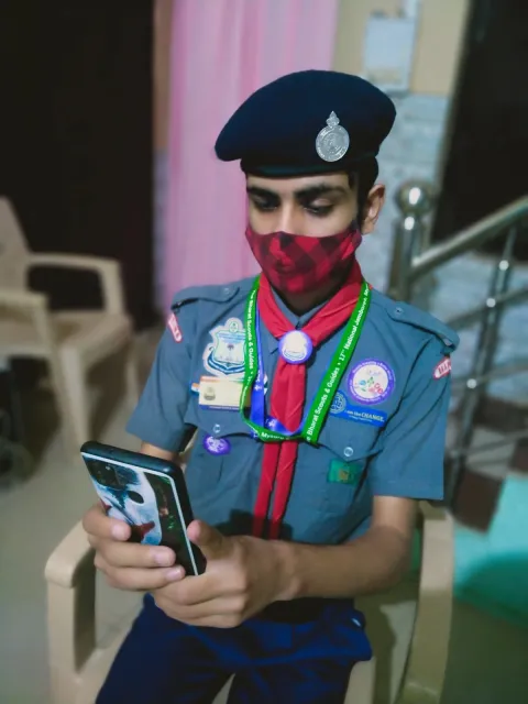 An Indian Scout looks at his phone during JOTA-JOTI