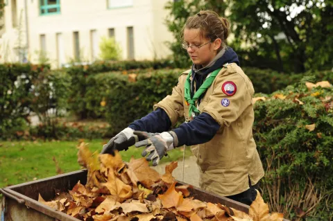 Scouts in Switzerland works cleaning their local community in autumn