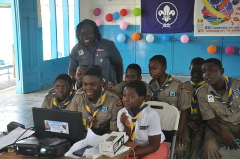 Scouts gather around a computer during the Jamboree On The Internet JOTA-JOTI
