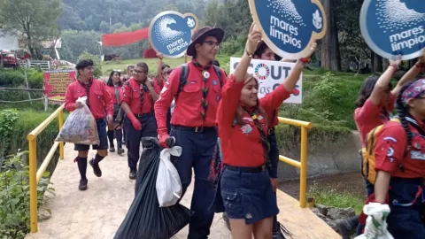 Scouts holding signs in supports of the Tide Turners challenge
