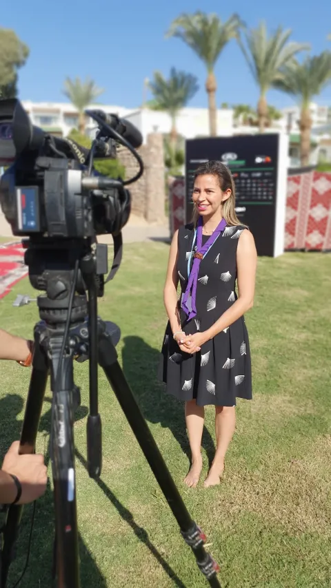 Grecia, a WOSM Youth Representative, does a TV interview during COP27 in Egypt for the Associated Press