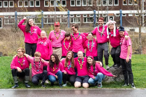 A group of "pinkies" or volunteers at the Kandersteg International Scout Centre pose in their bright pink shirts