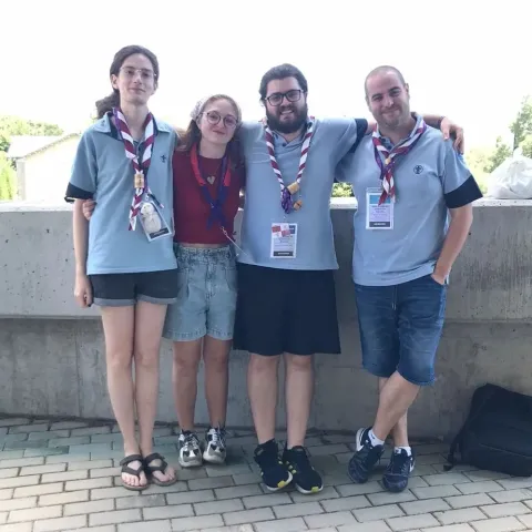 Four Scouts with their uniforms stand in front of the camera.