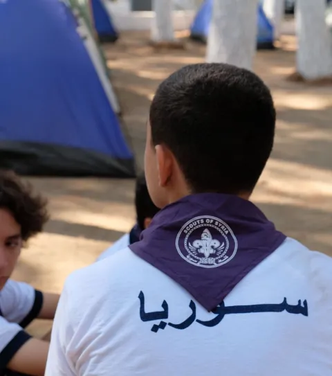 Scout from Syria faces away from the camera