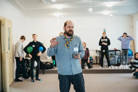 A Scout stands in a middle of a group.