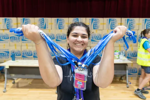 A volunteer holds up a stack of badges at the World Scout Jamboree