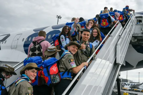 French Scouts board a plane en route to the World Scout Jamboree in South Korea
