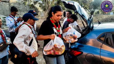 Moroccan Scout carries supplies for earthquake relief efforts