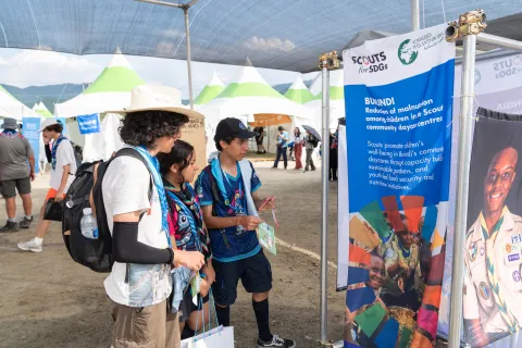 Three Scouts check out the outdoor exhibitions at the SDG Maeul during the World Scout Jamboree