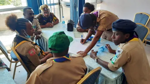 Scouts engage in a group discussion on gender equality issues at a training session