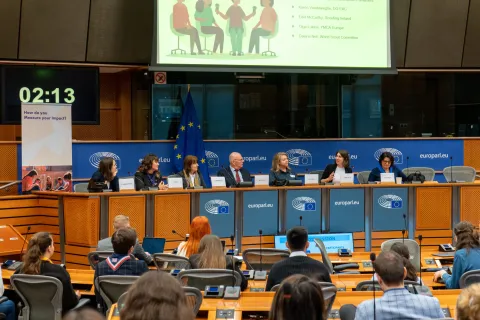 Seven people share during a panel discussion at the European Parliament.