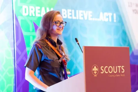 Máire, in WOSM Scout uniform, speaks during the World Scout Conference.