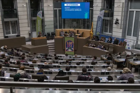 Young people sit at the Flemish Parliament.