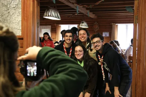 A planning team member takes a picture of 4 Rovers that smile at the camera.