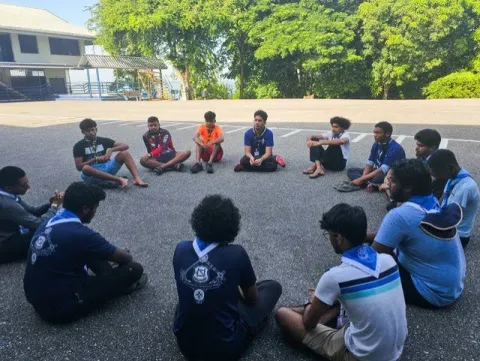 Scouts TT in a circle having a chat