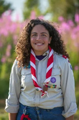 Amy, wearing her Scout uniform, smiles.