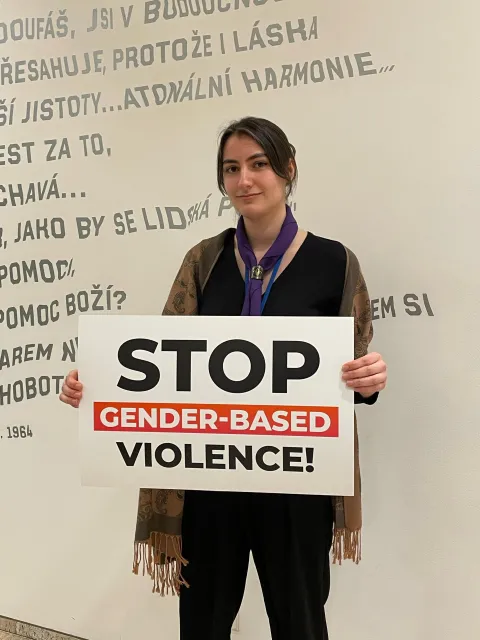 Emily Jones with a sign to stop gender-based violence